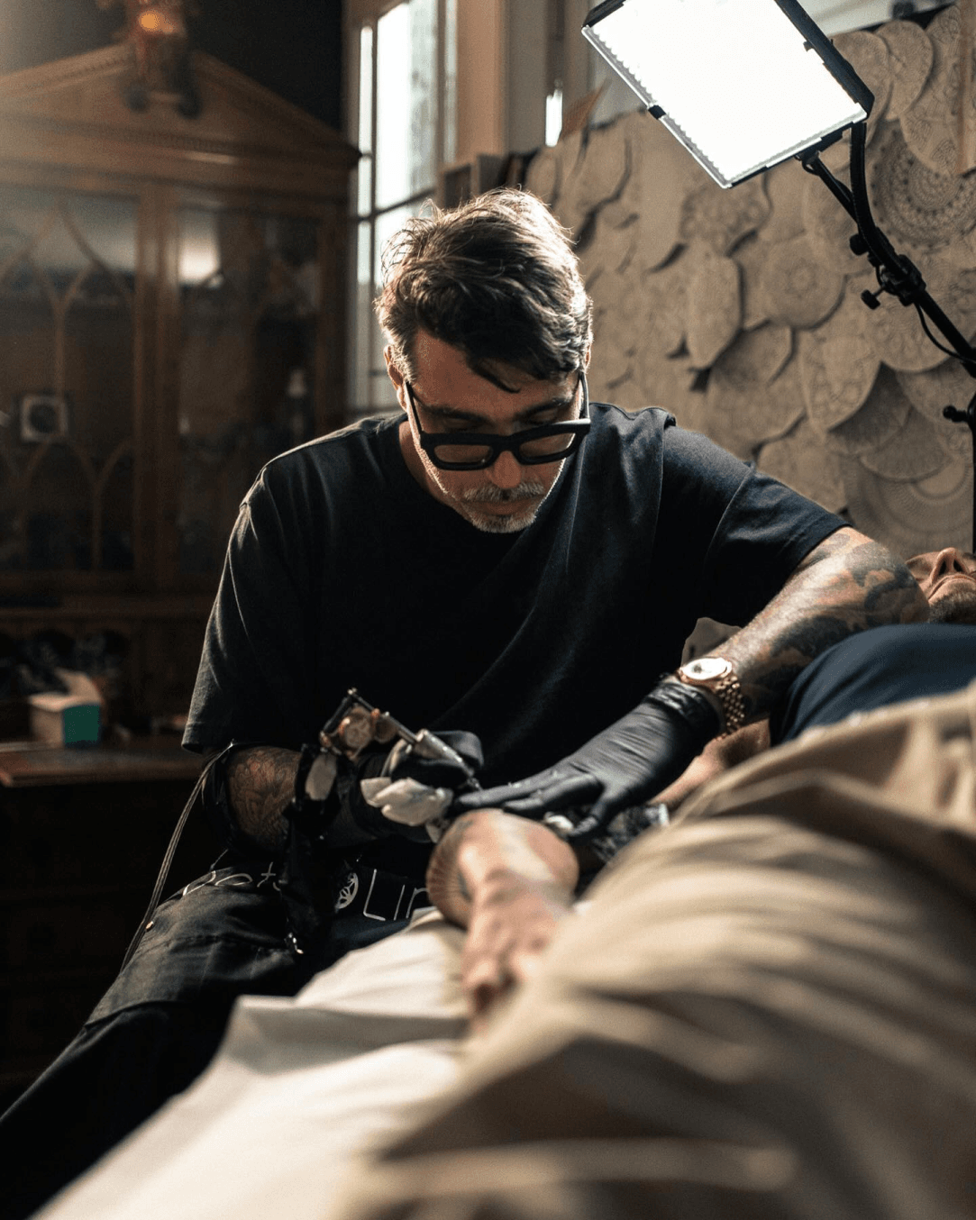 Chaim Machlev tattooing in his Berlin DotsToLines studio.